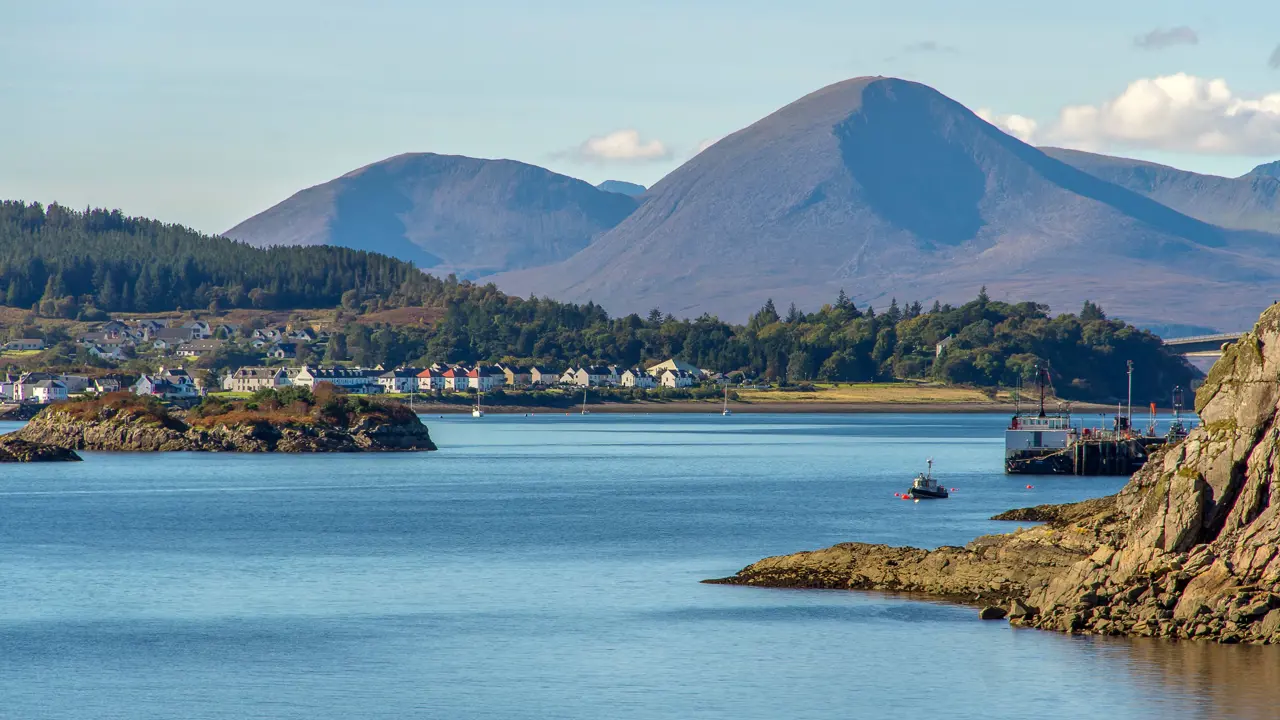 View of the Kyle of Lochalsh with Scottish Highland mountains behind it 