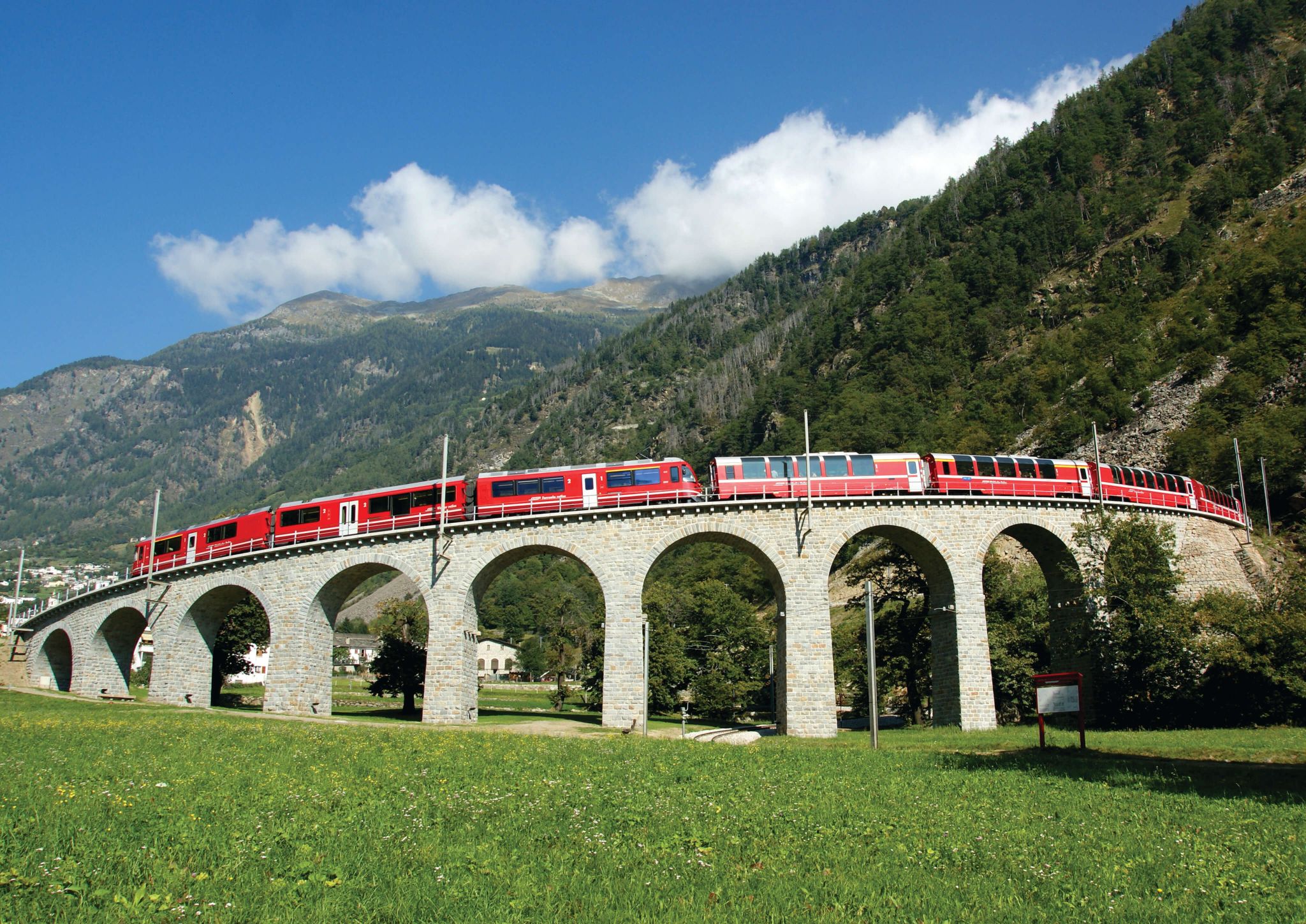The Bernina Express going across Brusio Spiral Viaduct, Switzerland
