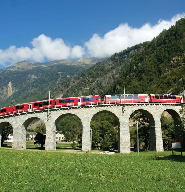 The Bernina Express going across Brusio Spiral Viaduct, Switzerland